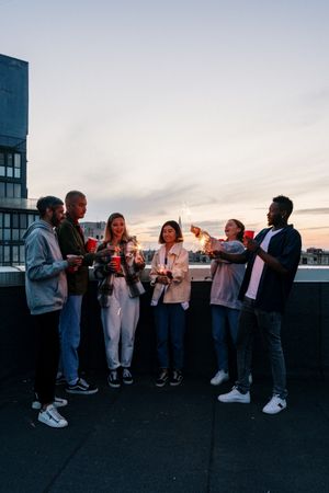 Friends holding sparklers, photo by cottonbro studio on Pexels