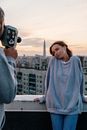 Woman in Gray Sweater Holding Black Camera