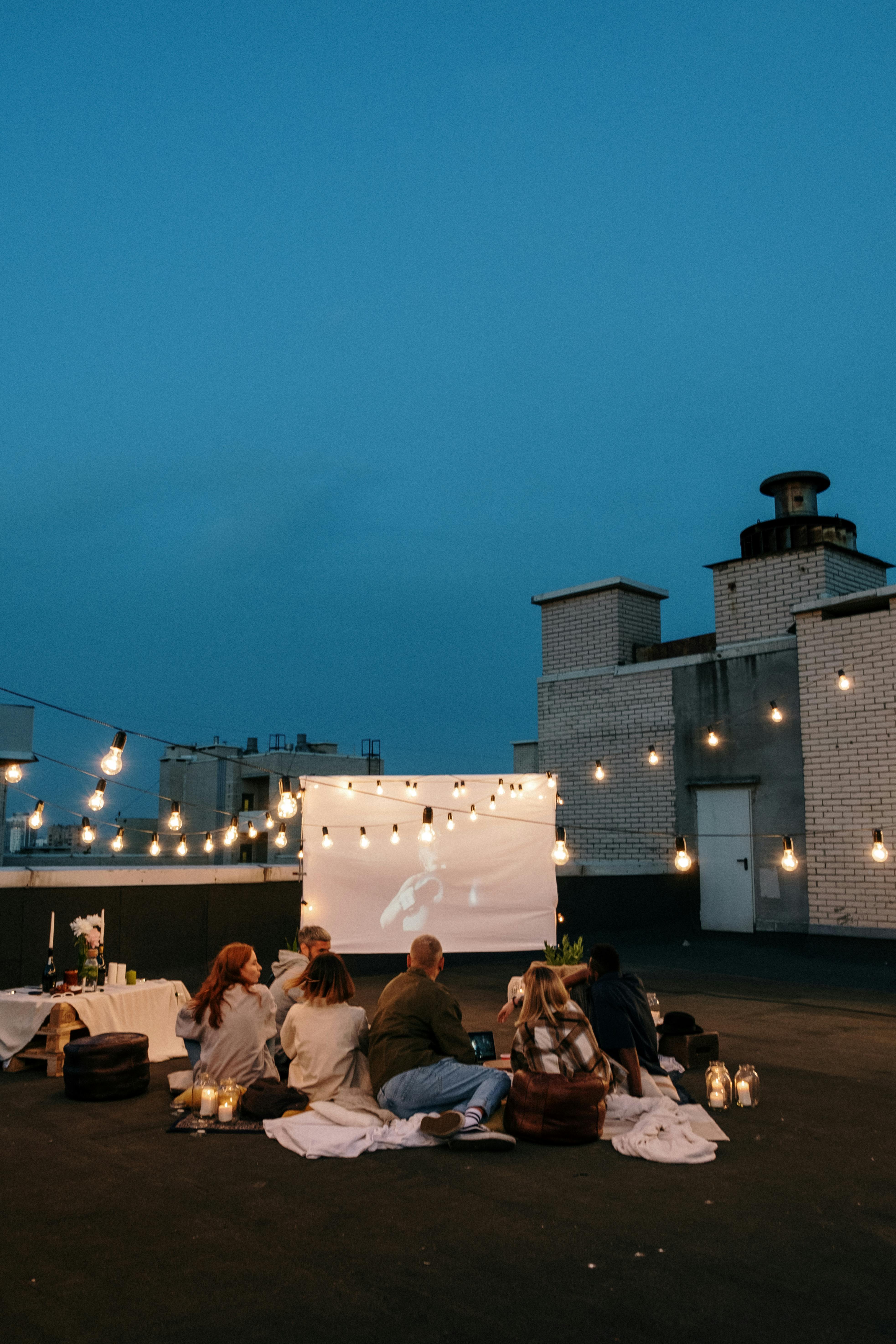 people sitting on chairs near building during night time