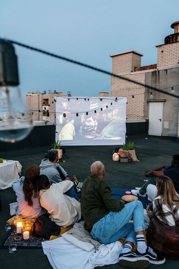 Residents watching a big community screen