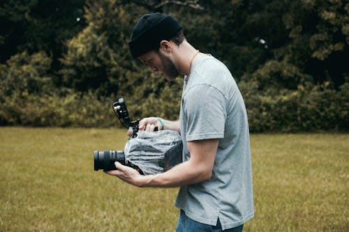 Man in Gray Crew Neck T-shirt Recording a Scene