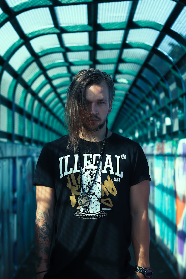 Stylish Man Standing In Colorful Tunnel