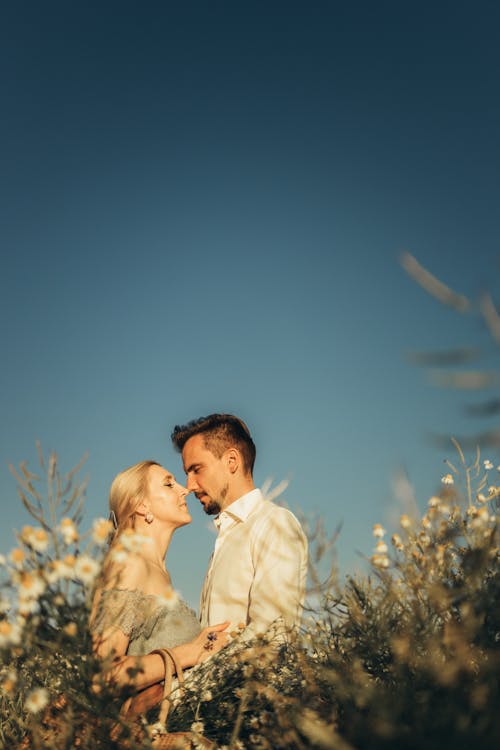 Free Couple Standing on a Flower Field Stock Photo