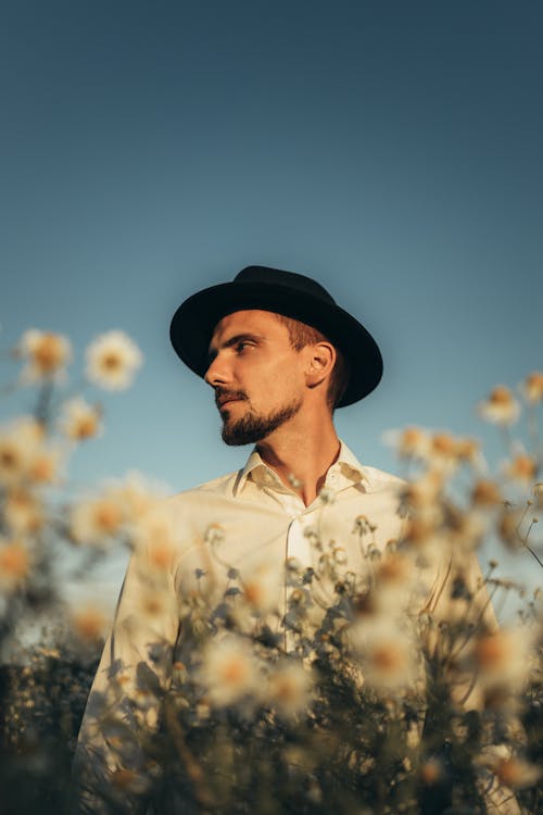 Man in White Button-Up Shit Wearing a Fedora Hat