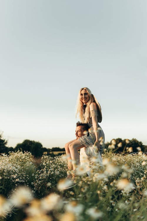 Smiling Woman Riding on Man's Shoulders