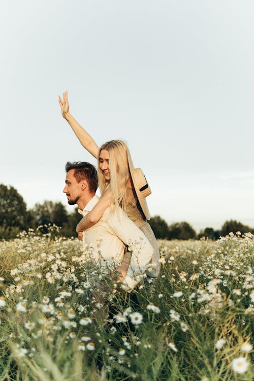 Smiling Woman Riding on Man's Back