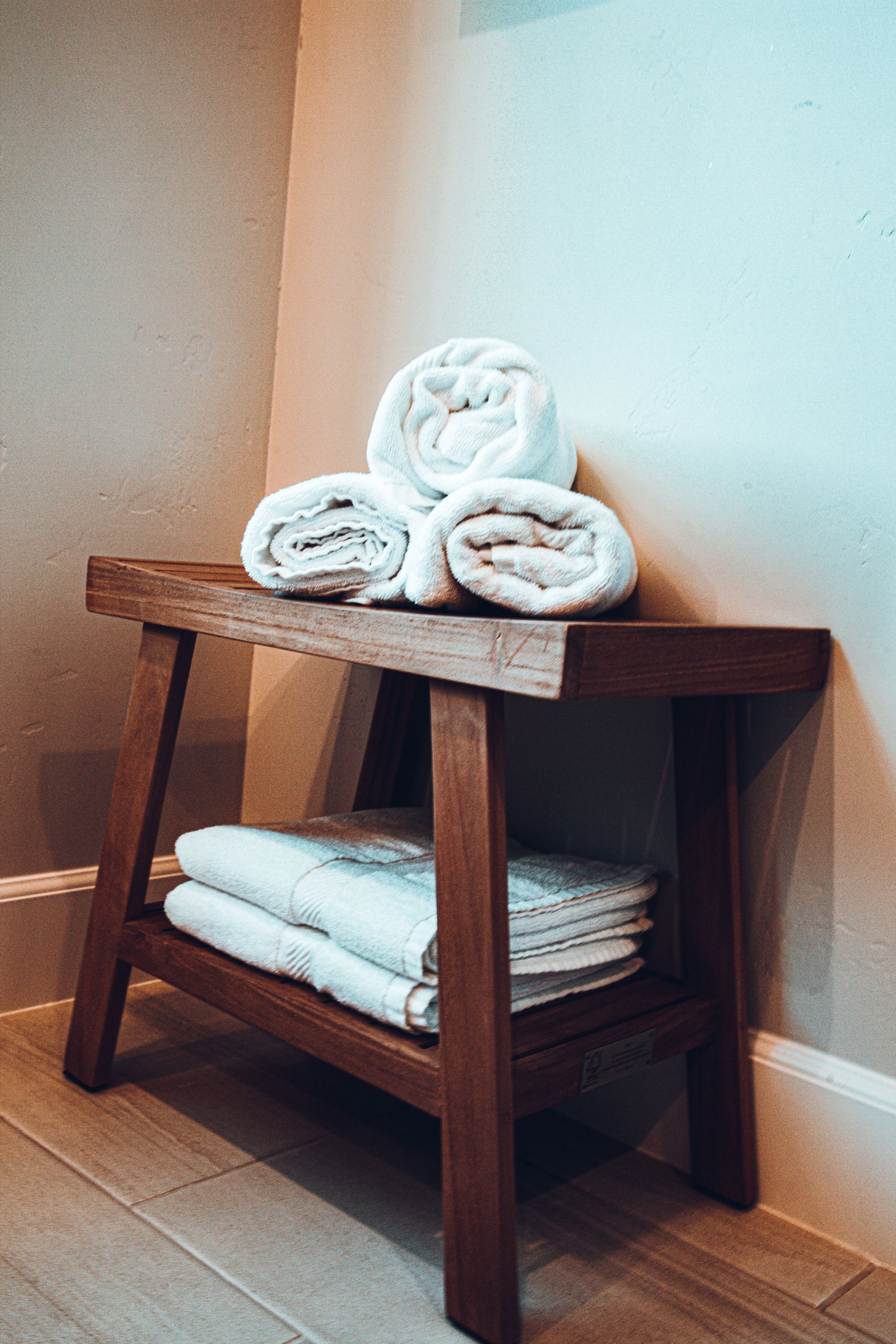 Bathroom shelving with folded towels and everyday essentials stored at accessible heights