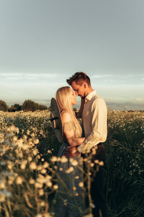Free Romantic Couple Standing on Flower Field Stock Photo