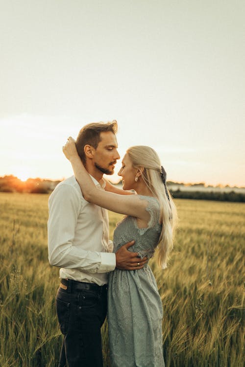 Romantic Couple Standing on a Field