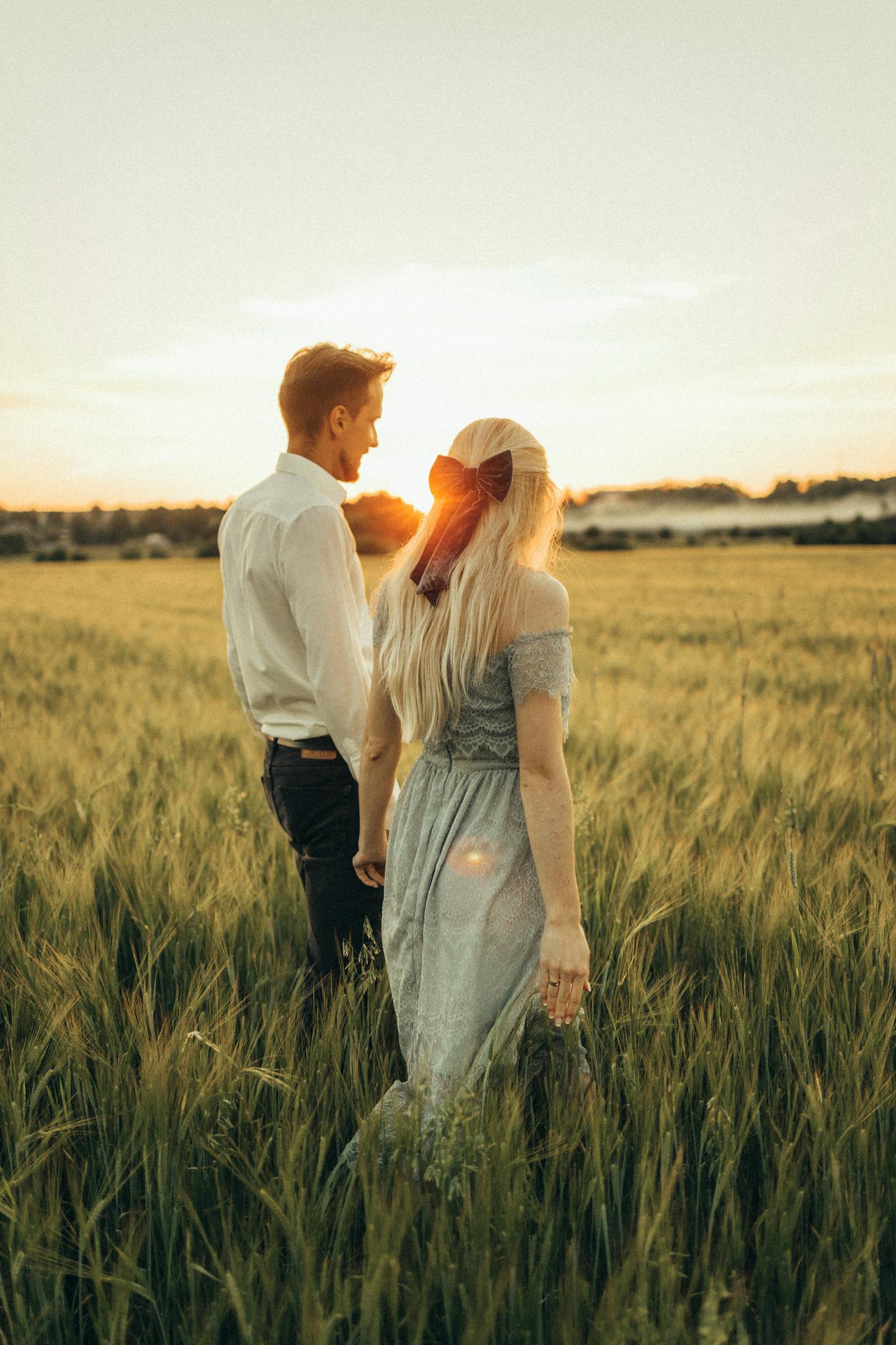 Couple Standing on Green Grass Field