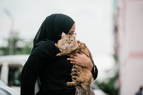 A Woman Carrying Her Cat 