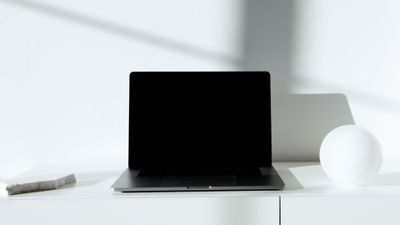 Laptop on a minimalist white desk — photo by Artem Podrez on Pexels