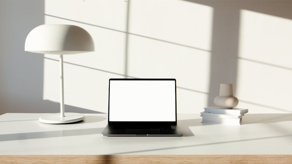 Ultimate Smart Home Hub Comparison Guide for 2026: Top Picks Explained Minimalist desk setup featuring a laptop, stylish lamp, and books in natural light.
