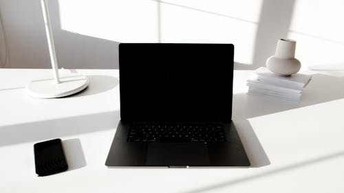 Free Black Laptop Computer on White Table Stock Photo