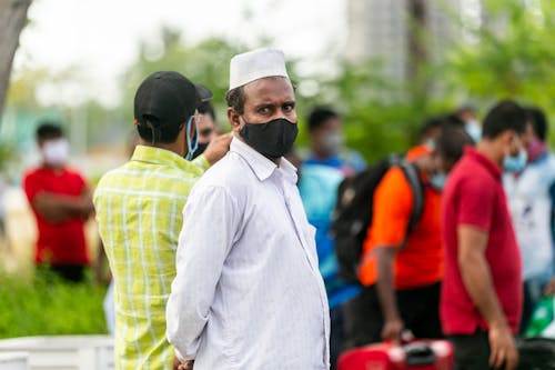 A Portrait of a Man in a Black Face Mask