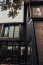 Majestic expensive luxury house with balcony and big wide transparent picture windows in daytime
