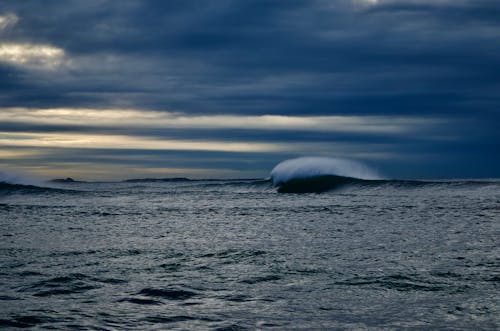 Body of Water Under Cloudy Sky