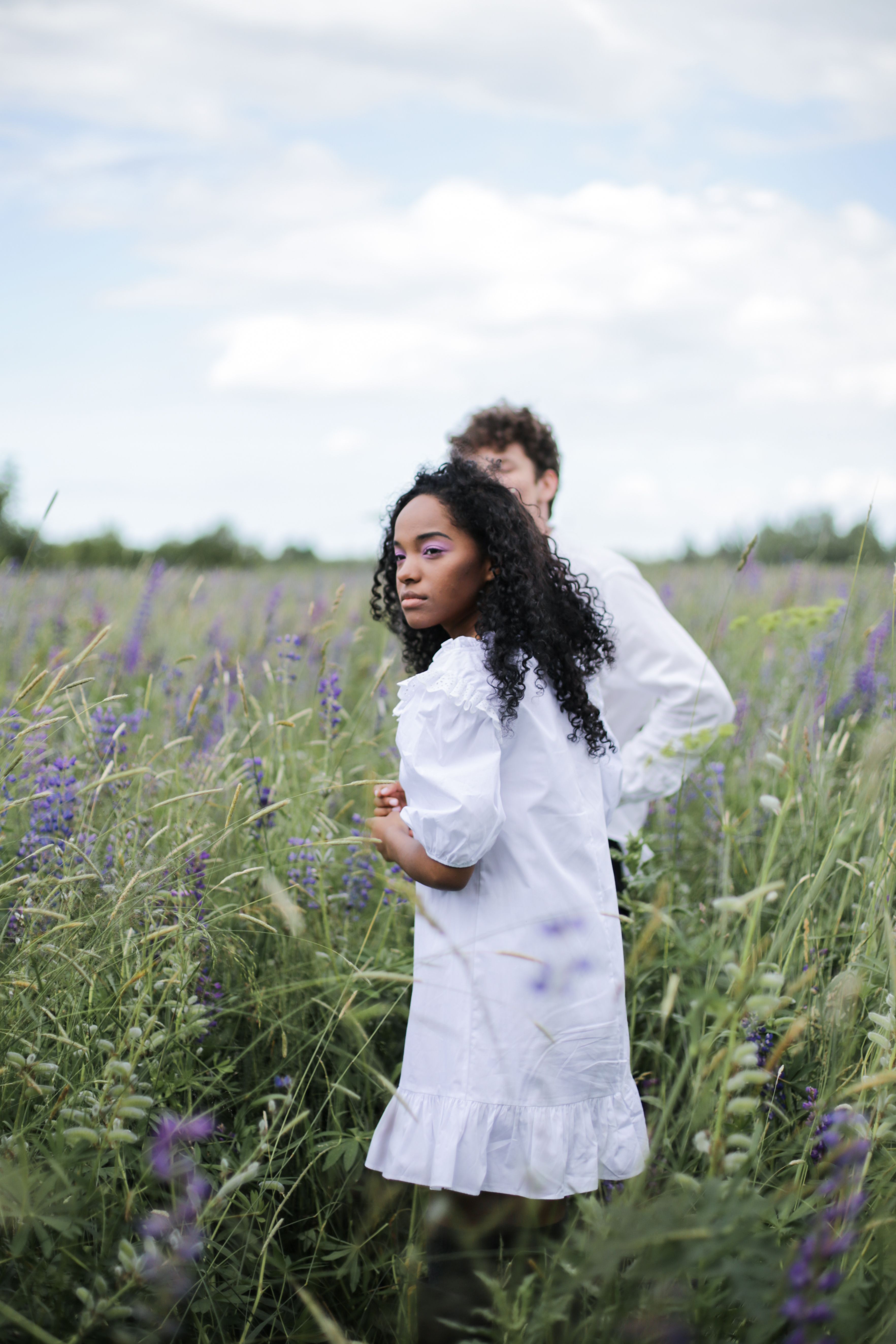 Man and Woman Holding Hands While Walking on Green Grass Field · Free ...
