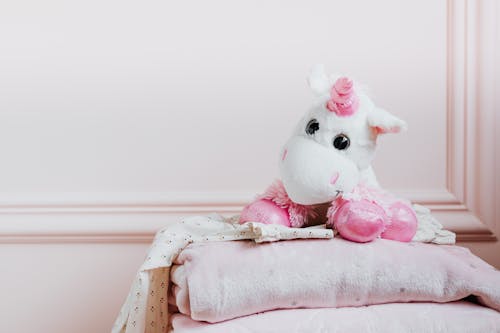 Free A Unicorn Stuffed Toy on a Blanket Stock Photo