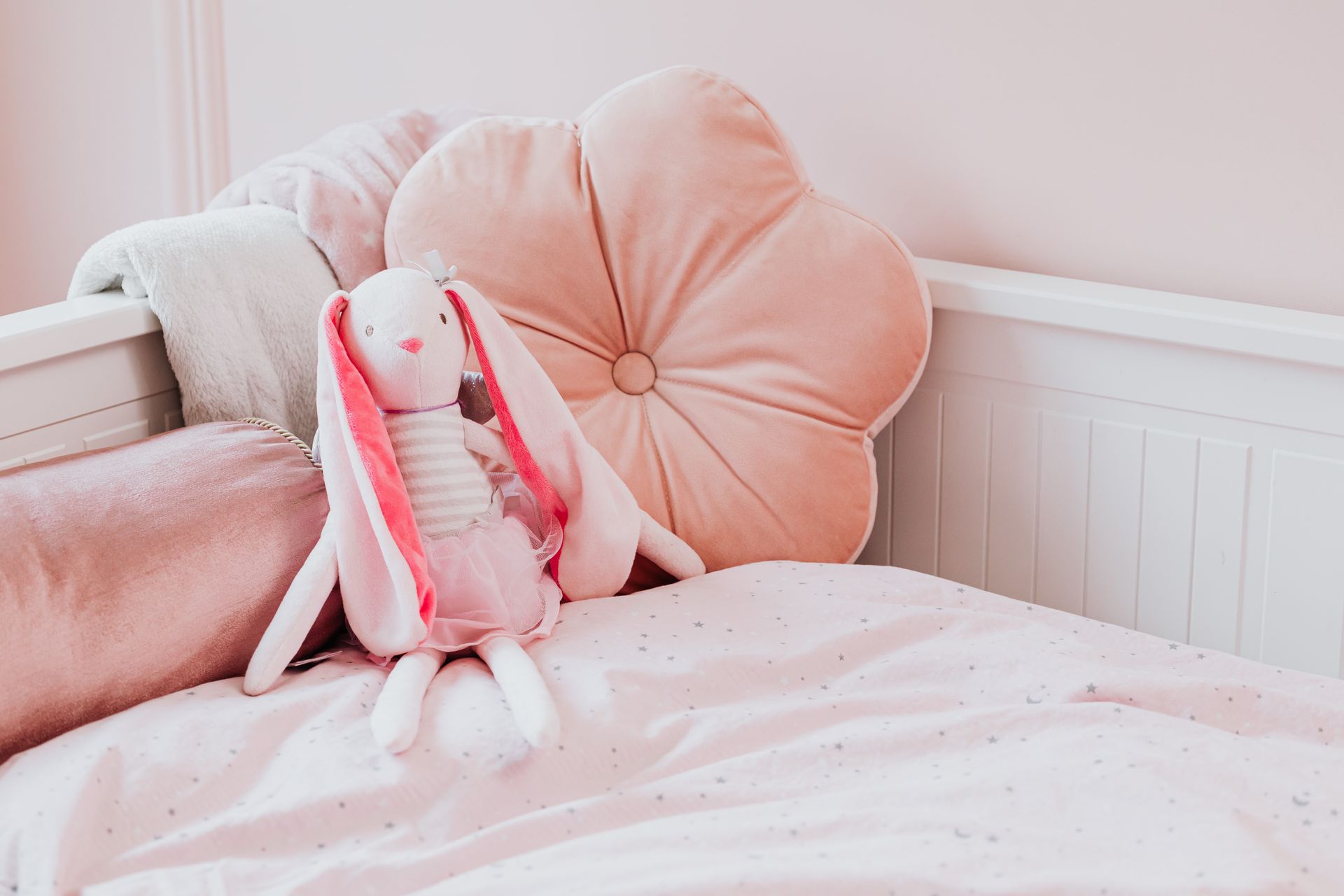 Pink Stuffed Toy and Pink Pillows on a Bed