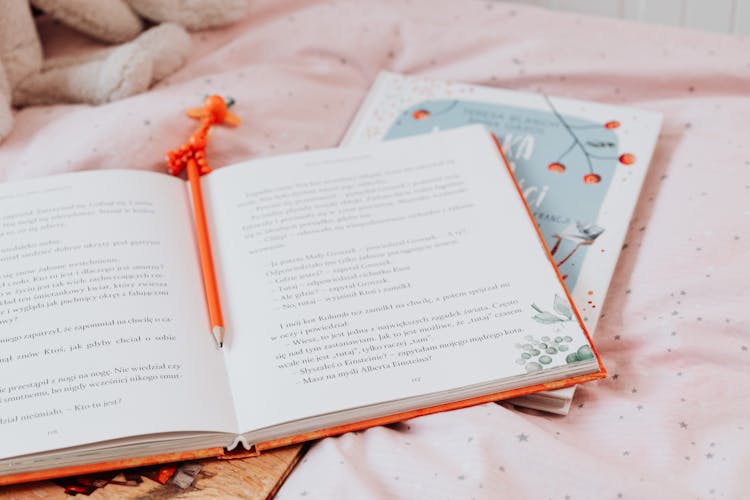 Orange Pencil On A Book