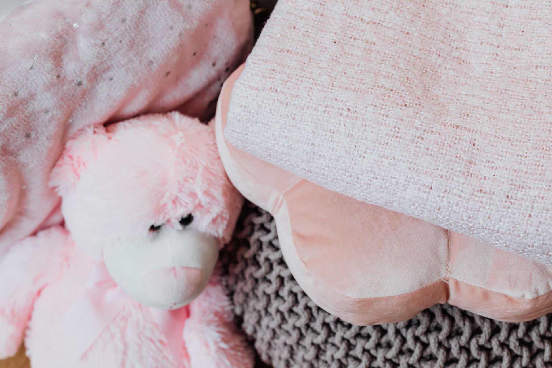 Close-up of a Pink Teddy Bear near Pillows