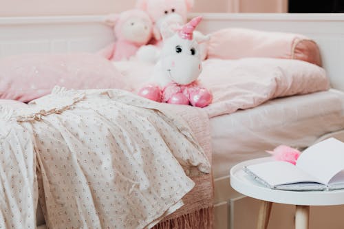 Pink and White Plush Toys on Bed