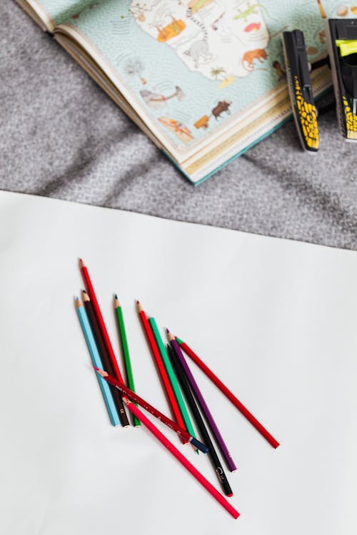 Free Coloring Pencils on White Textile Stock Photo