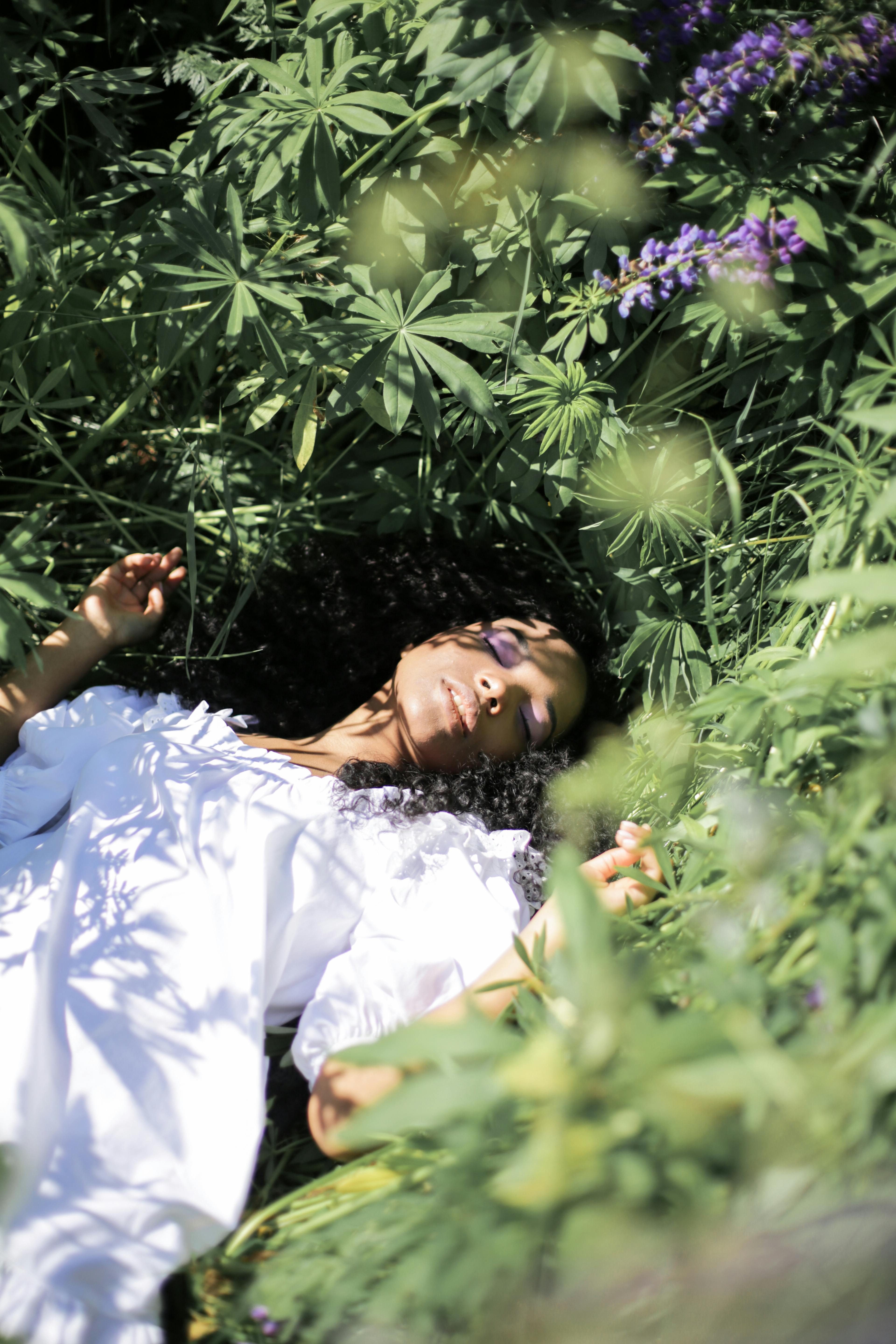 Woman in White Dress Lying on Green Grass Field · Free Stock Photo