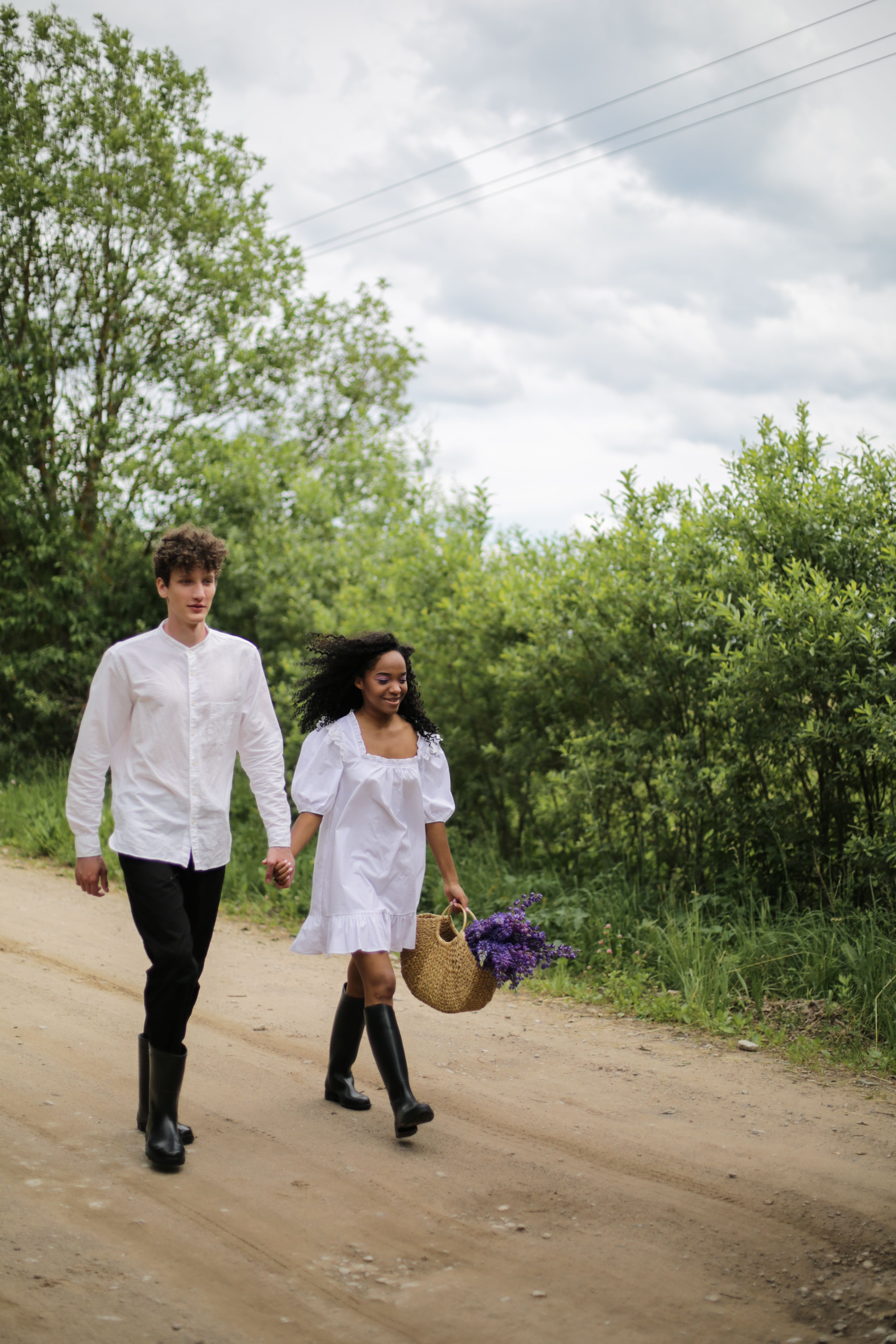 Girl in White Dress Walking on Dirt Road Between Green Trees · Free ...