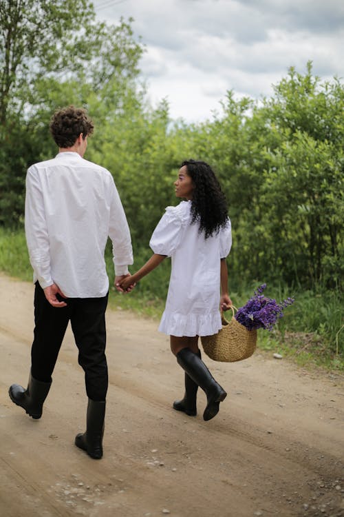 Woman in White Dress Shirt and Black Pants Standing Beside Woman in White Dress Shirt