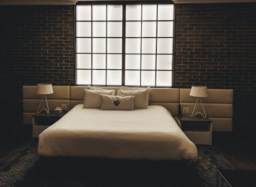 Free Interior of a Hotel Room with White Bed Stock Photo