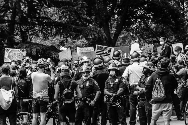 Black And White Photo Of Police Guarding Protesters