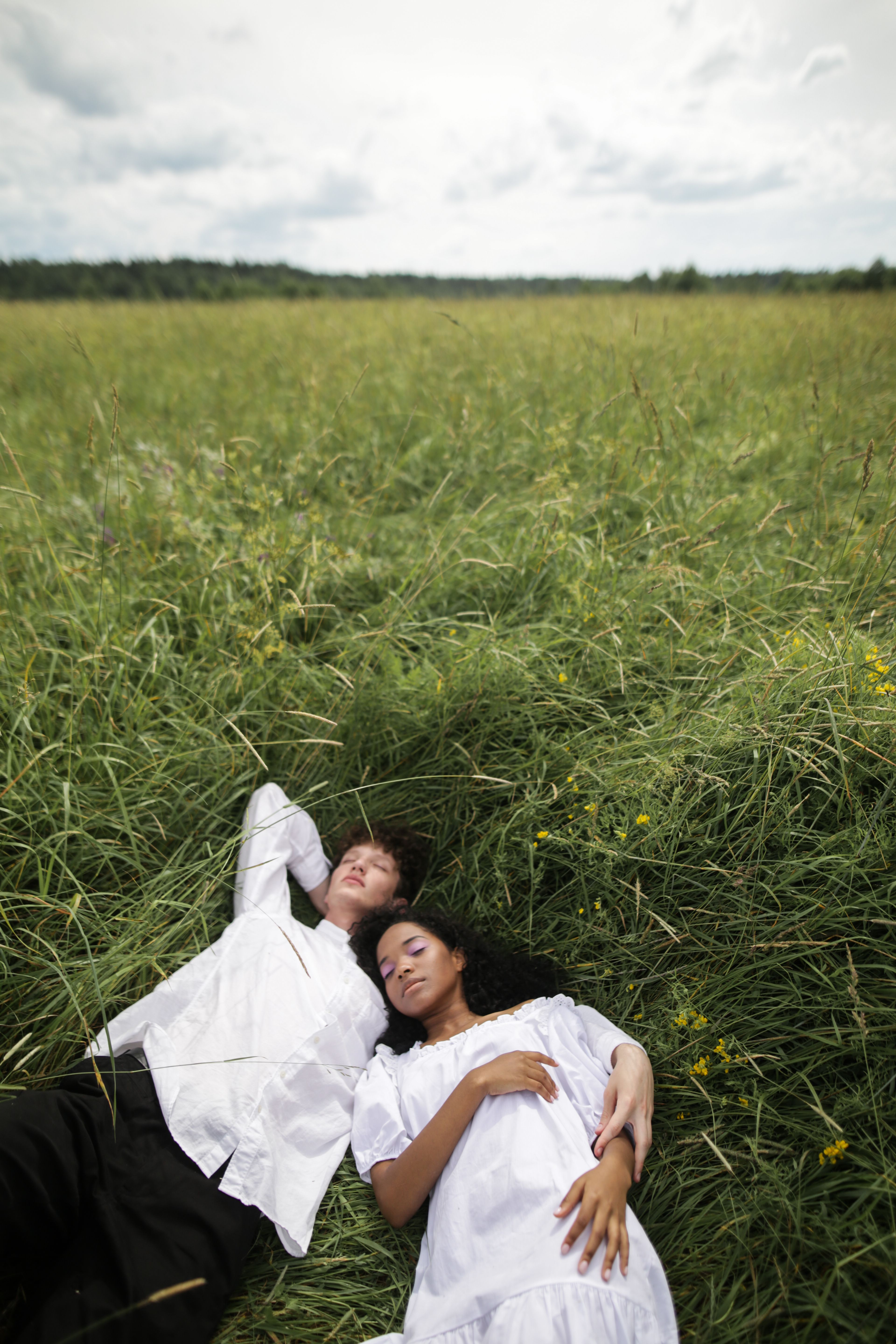 Man and Woman Holding Hands While Walking on Green Grass Field · Free ...