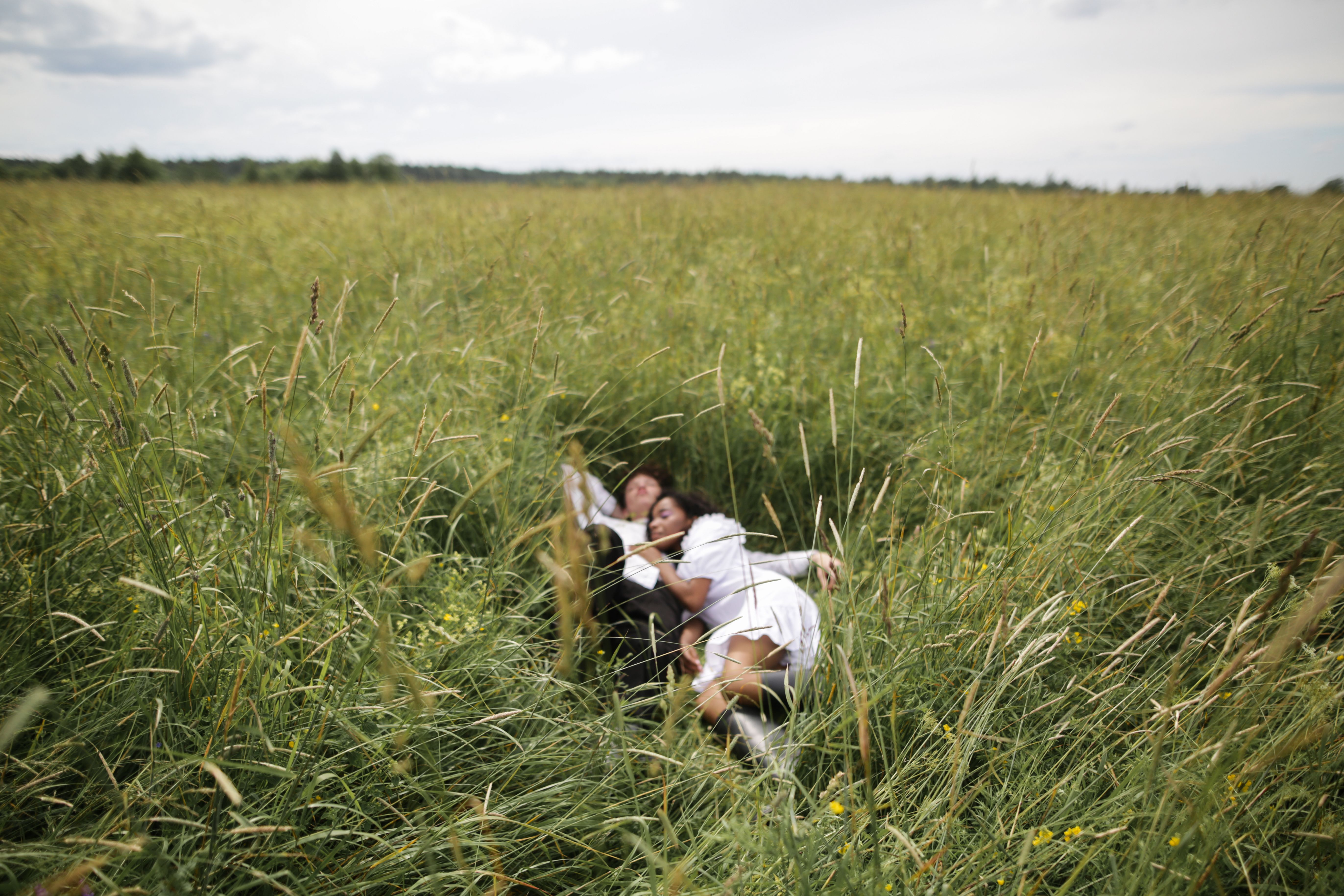 Man and Woman Holding Hands While Walking on Green Grass Field · Free ...