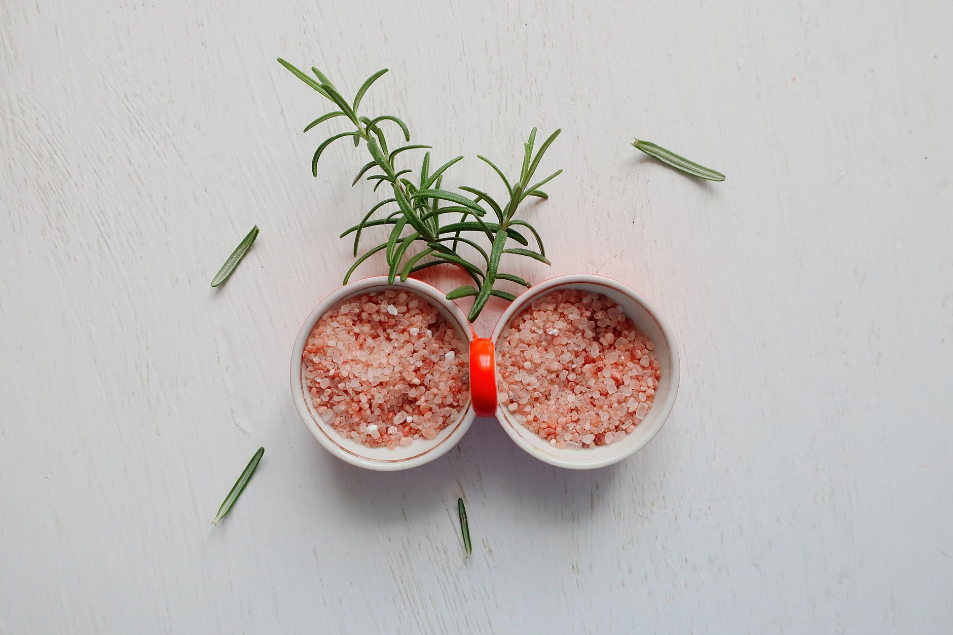 A set of small bamboo salt cellars holding different types of salts