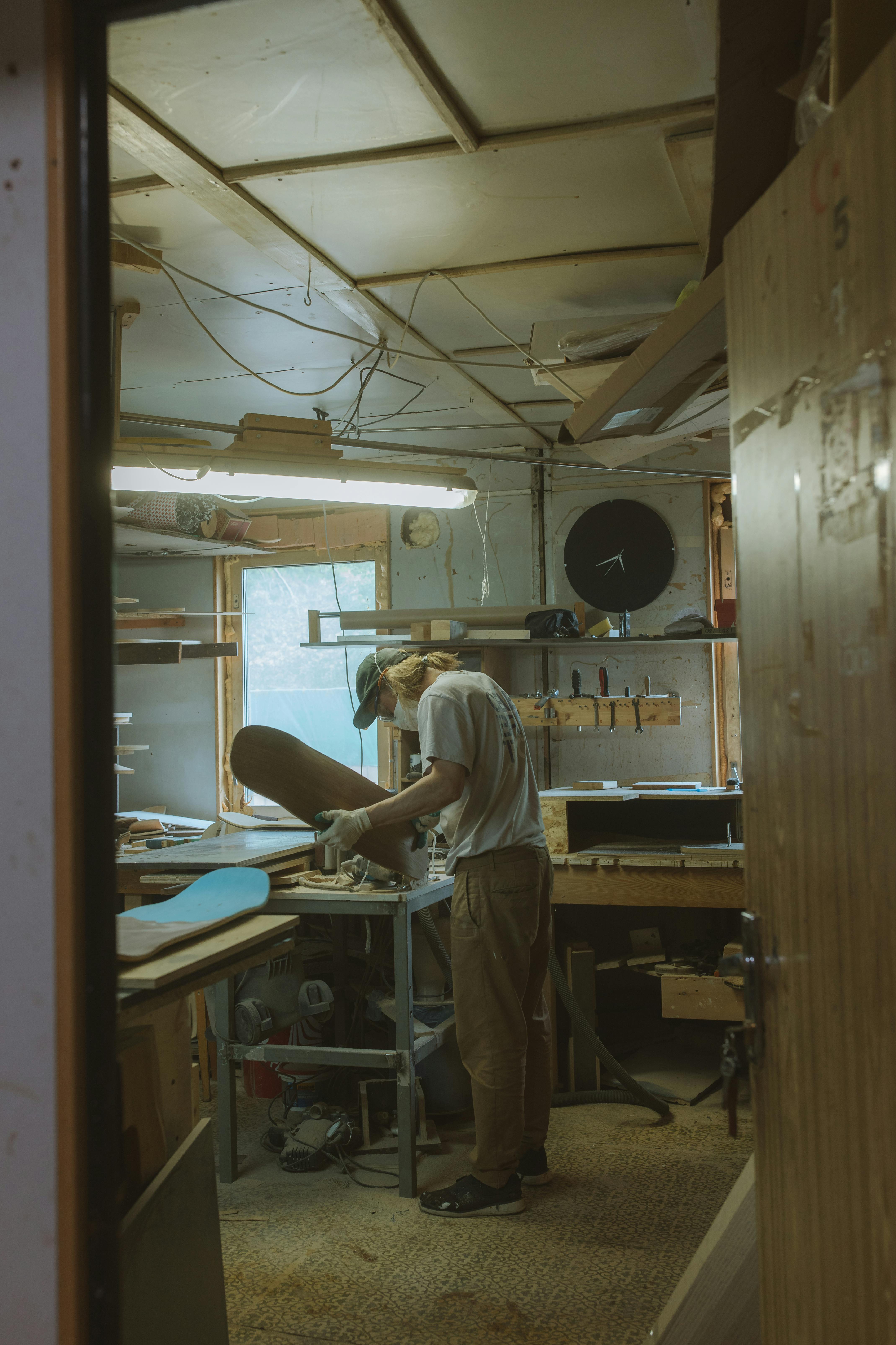 photograph of a man making a skateboard