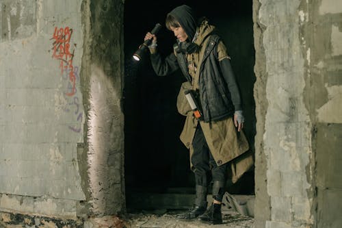 Man in Brown Jacket and Brown Pants Standing on Gray Concrete Floor