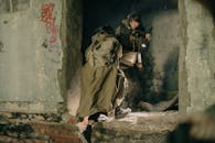 Man in Brown Coat Sitting on Gray Concrete Bench