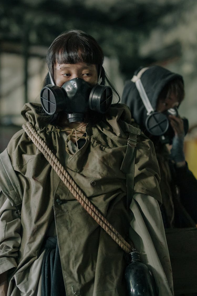 Man In Green Jacket Wearing Black Gas Mask