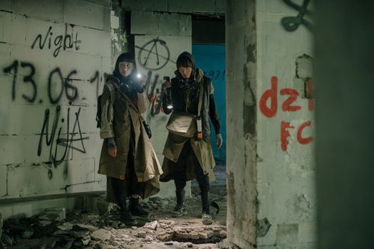 Man in Black Jacket Standing Beside Woman in Brown Coat
