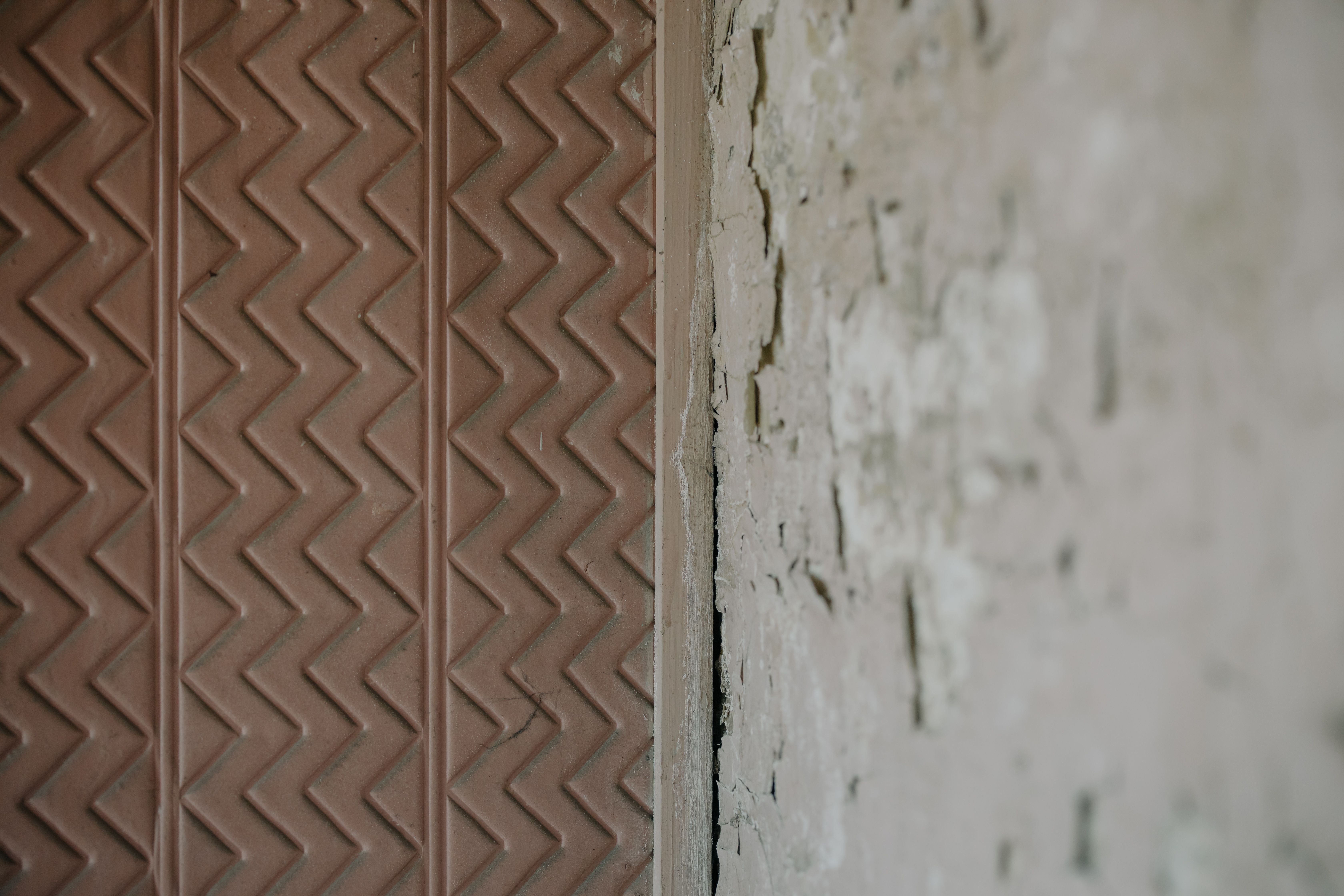 Wallpapering in Seven Kings — careful masking before painting begins