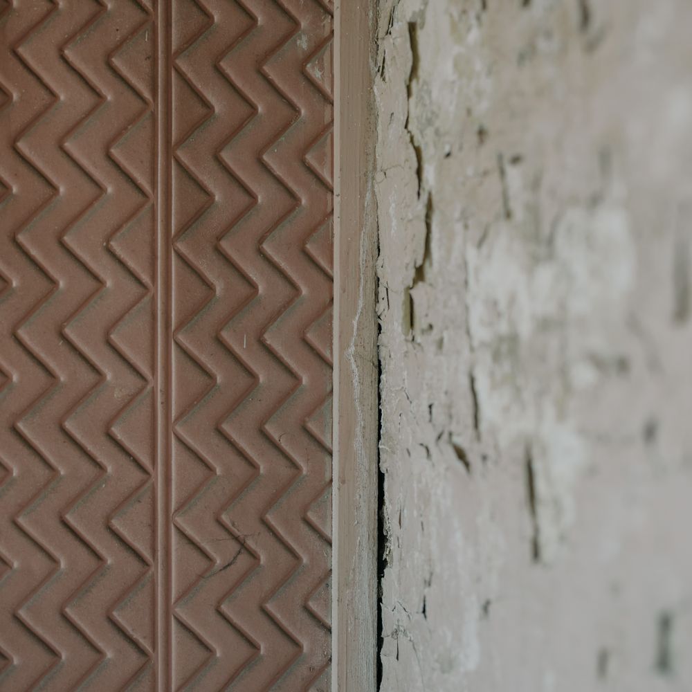 Wallpapering in Seven Kings — careful masking before painting begins