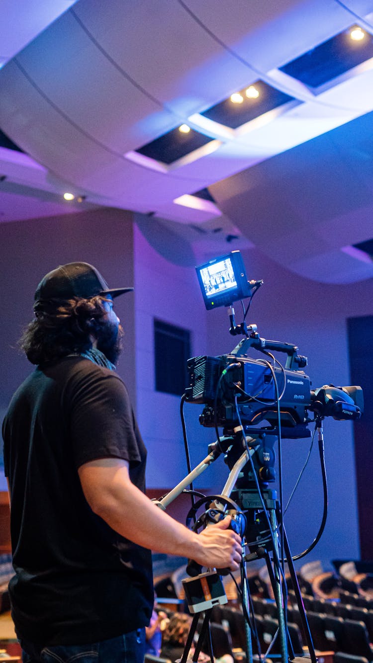 Professional Videographer Shooting Stage During Concert