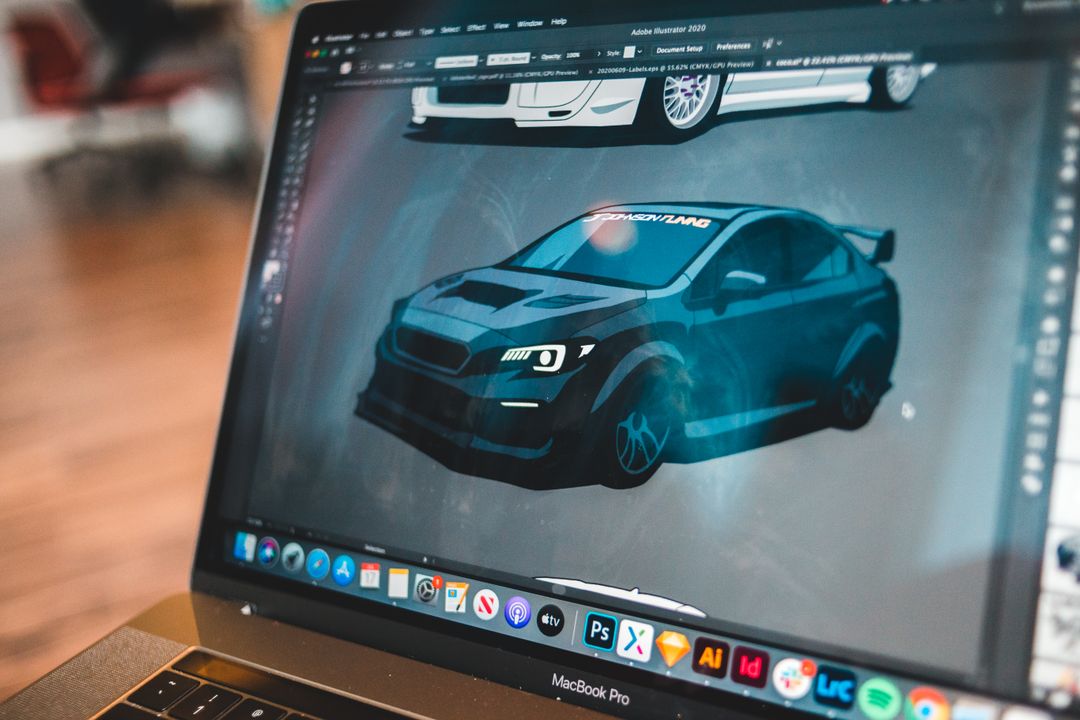 Selective focus of sports car image in graphic editor on screen of contemporary laptop
