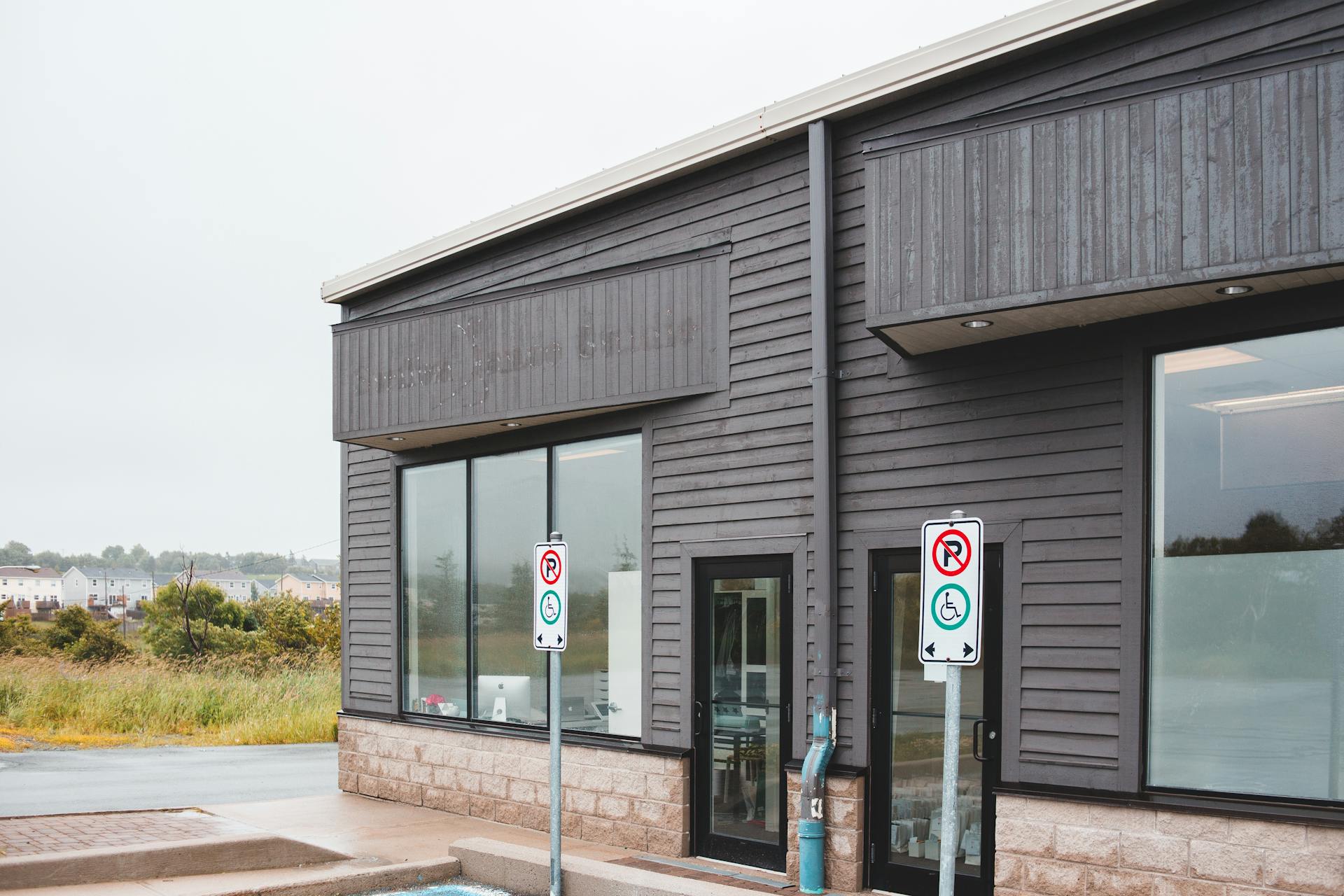 Contemporary suburban commercial building facade with signage and ample copy space.