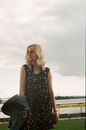 Dreamy woman in summer dress with photo camera