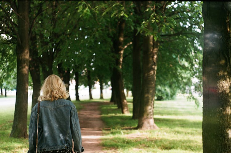 Woman In Denim Jacket Walking In Alley