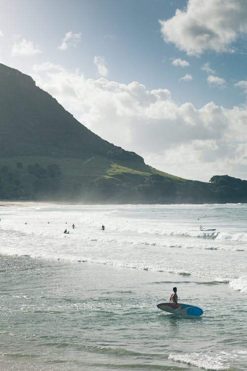 Photo of People Surfing at the Beach