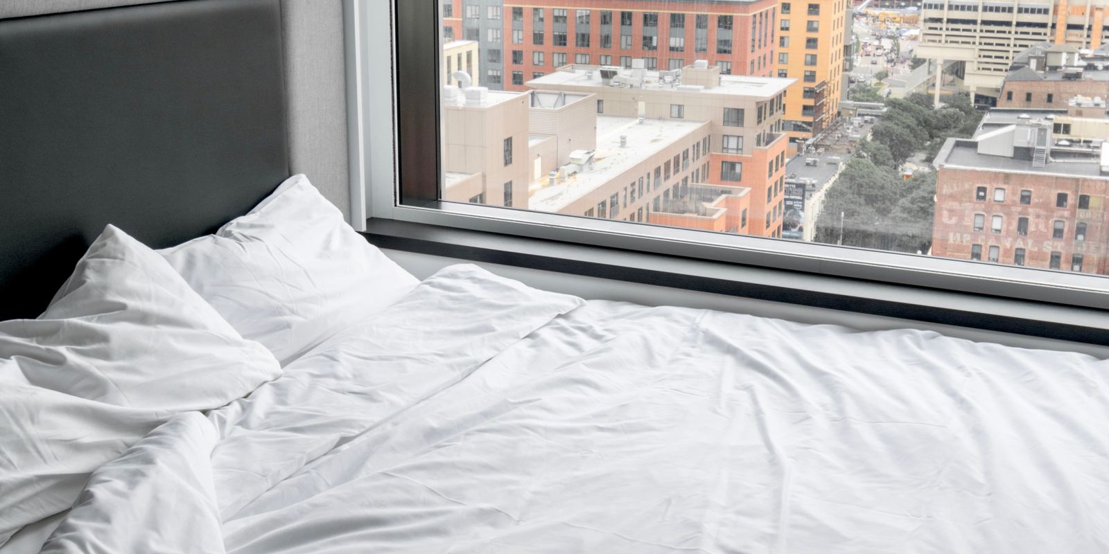 Modern hotel room with a large window and city view